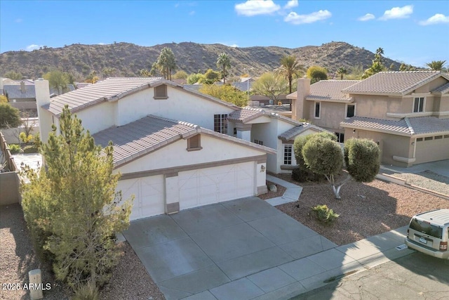 view of front of house with a garage and a mountain view