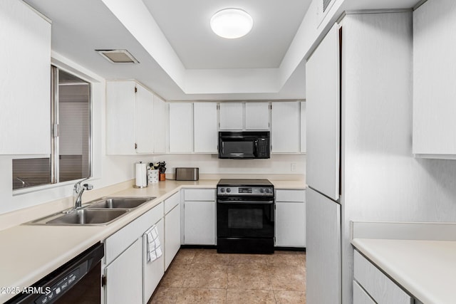 kitchen featuring white cabinetry, sink, light tile patterned floors, and black appliances