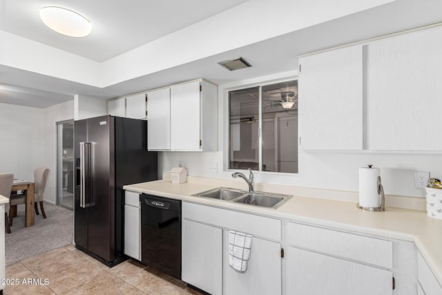 kitchen with light tile patterned flooring, high quality fridge, white cabinetry, dishwasher, and sink