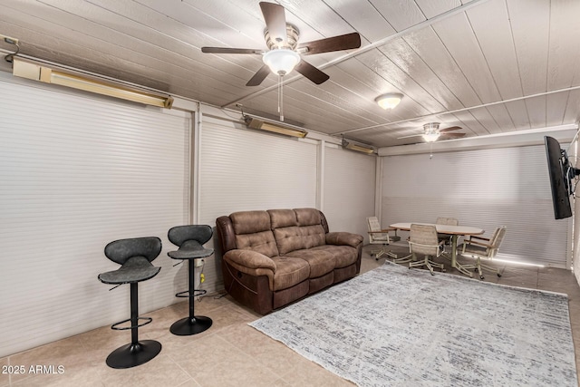 living room featuring ceiling fan, light tile patterned floors, and wood ceiling