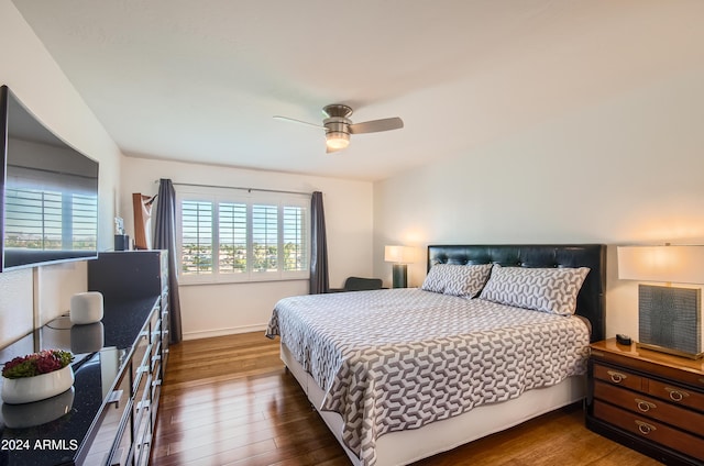 bedroom featuring ceiling fan and dark hardwood / wood-style floors