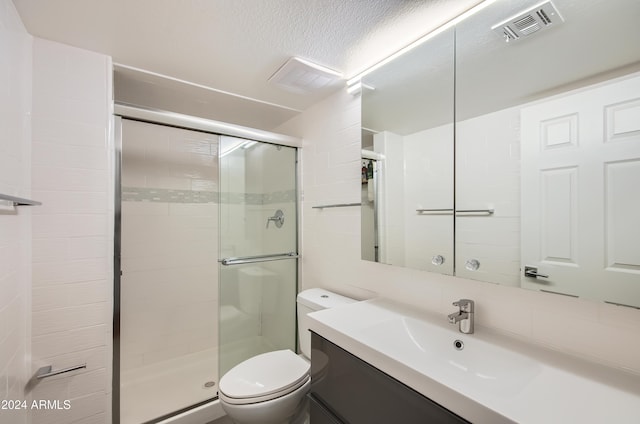 bathroom featuring backsplash, vanity, toilet, and walk in shower