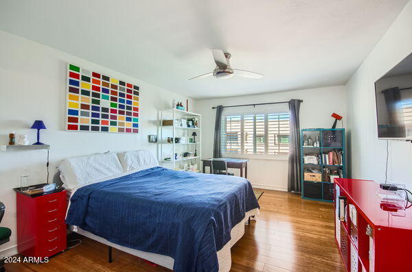 bedroom with ceiling fan and dark wood-type flooring