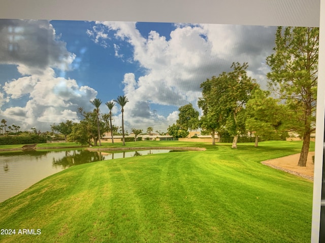 view of community featuring a yard and a water view