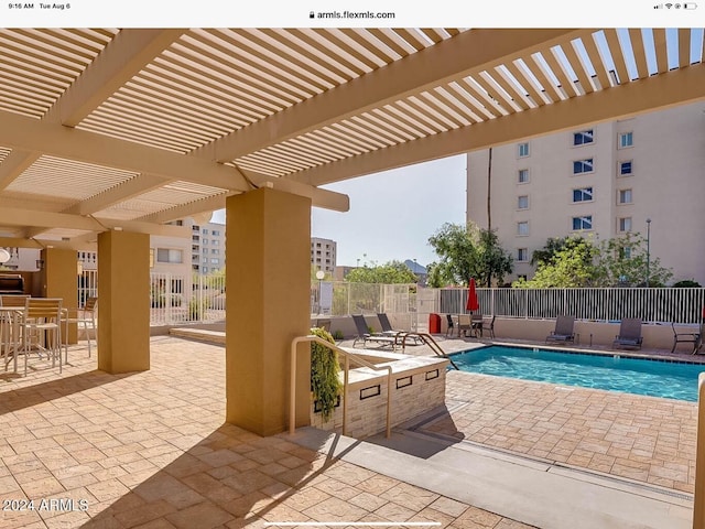 view of swimming pool with a patio area and a pergola