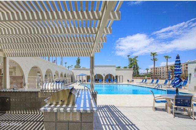 view of pool with a pergola, area for grilling, and a patio