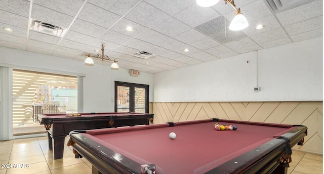 game room featuring a paneled ceiling, light tile patterned flooring, and billiards