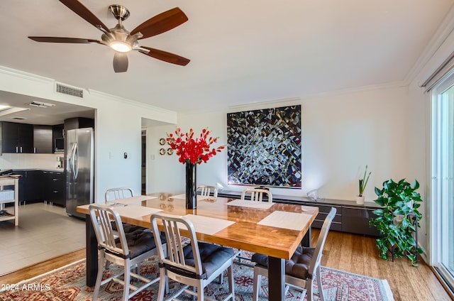 dining room featuring ceiling fan, light wood-type flooring, and ornamental molding