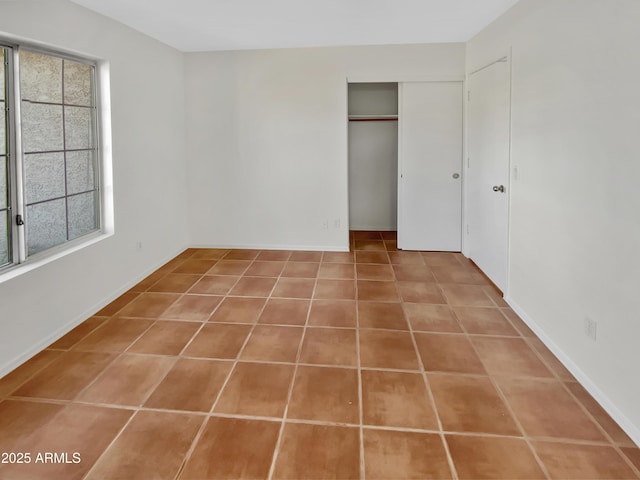 unfurnished bedroom featuring tile patterned flooring