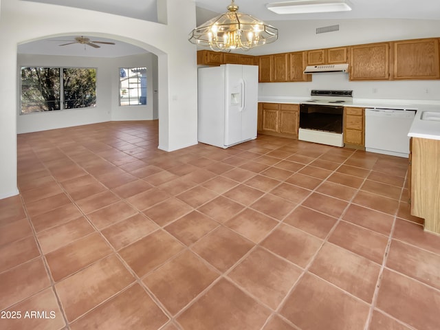 kitchen featuring pendant lighting, light tile patterned floors, white appliances, lofted ceiling, and ceiling fan with notable chandelier