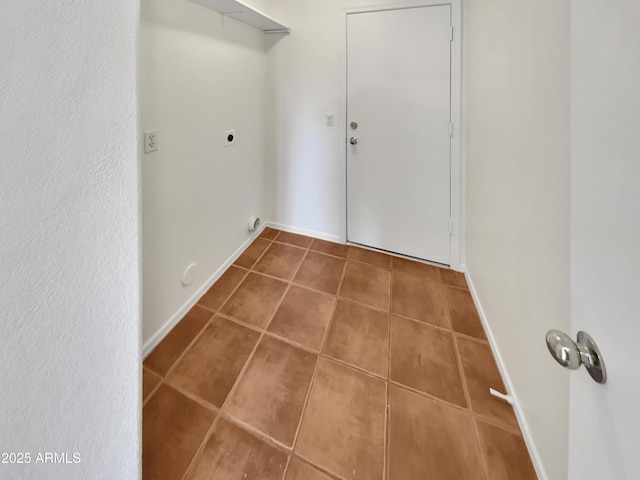 laundry area with electric dryer hookup and tile patterned floors