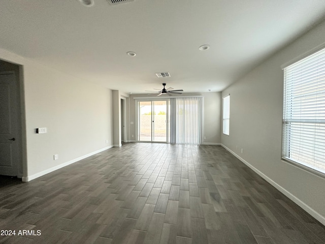 unfurnished room with ceiling fan and dark hardwood / wood-style flooring