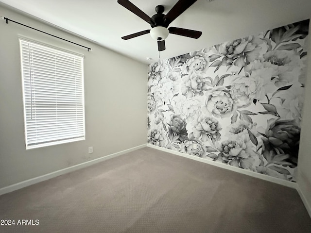 carpeted spare room with plenty of natural light and ceiling fan