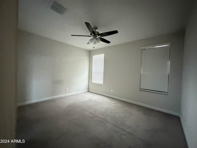 spare room featuring carpet flooring and ceiling fan