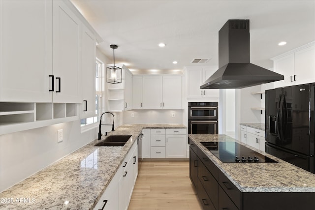 kitchen with sink, white cabinetry, a center island, black appliances, and island exhaust hood