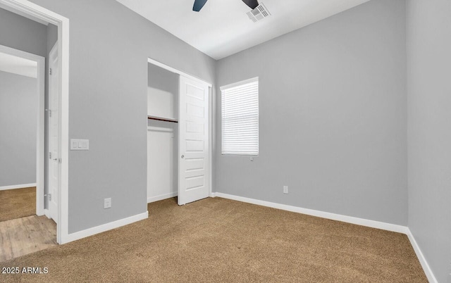 unfurnished bedroom featuring carpet flooring, ceiling fan, and a closet