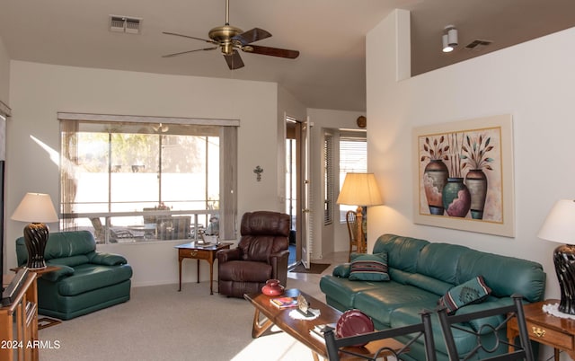 living room with carpet, visible vents, and a ceiling fan