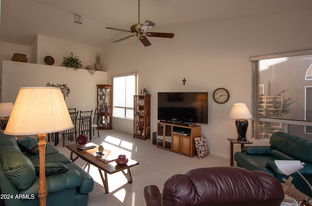 living area featuring ceiling fan, high vaulted ceiling, and carpet flooring