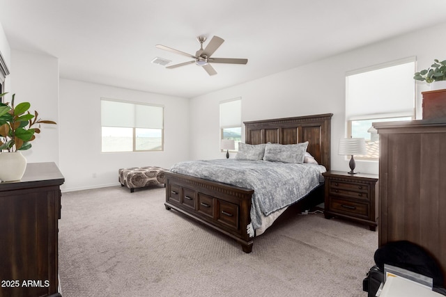 bedroom featuring visible vents, baseboards, a ceiling fan, and light colored carpet