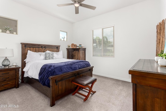 carpeted bedroom with ceiling fan and baseboards