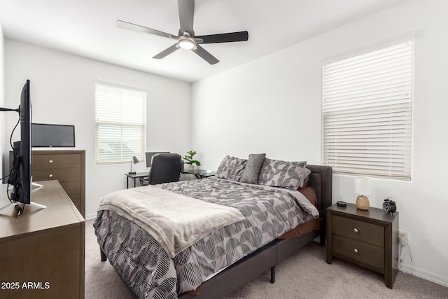 bedroom featuring light carpet, baseboards, and a ceiling fan