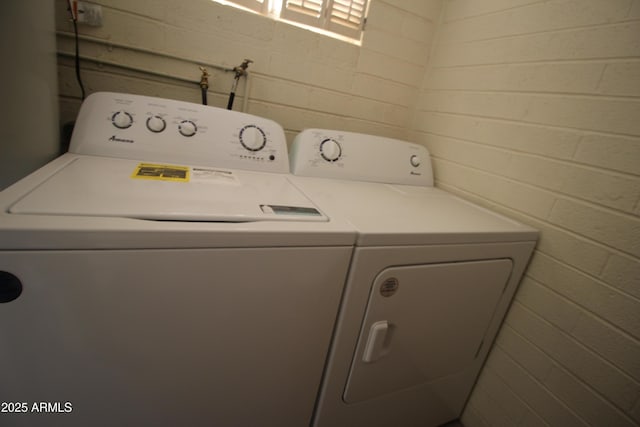 laundry area with independent washer and dryer