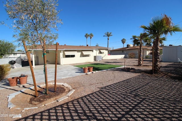 rear view of house featuring central AC unit and a patio