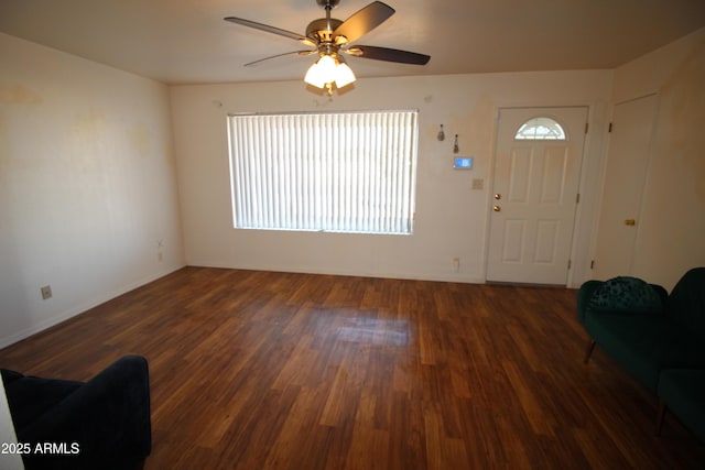 unfurnished living room featuring ceiling fan and dark hardwood / wood-style flooring