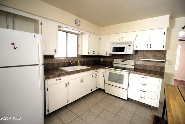 kitchen with sink, white appliances, decorative backsplash, and white cabinets