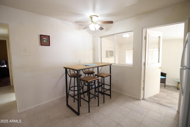 tiled dining area featuring ceiling fan