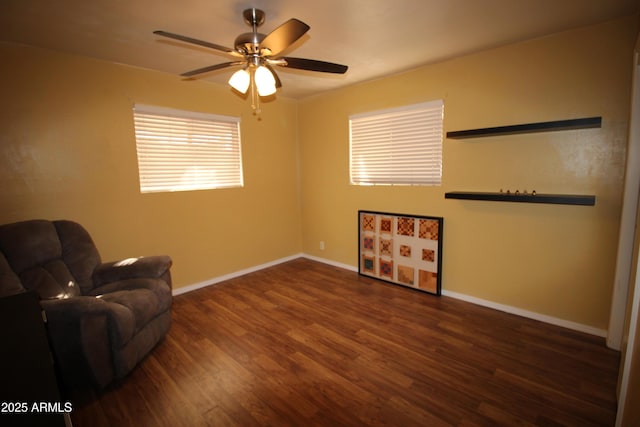 living area featuring dark hardwood / wood-style flooring and ceiling fan