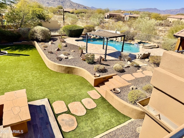 view of swimming pool featuring a fenced backyard, a mountain view, a fenced in pool, and a patio