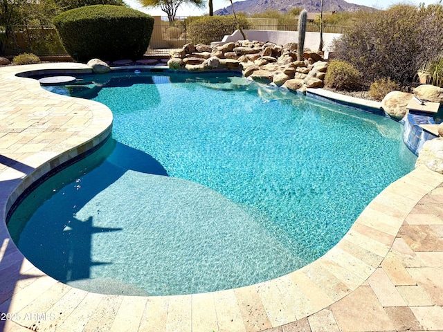 view of pool with a mountain view, fence, and a fenced in pool