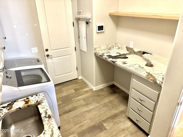 laundry room with washer / dryer, light wood-style flooring, and baseboards