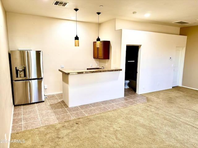 kitchen with visible vents, light carpet, hanging light fixtures, and stainless steel refrigerator with ice dispenser