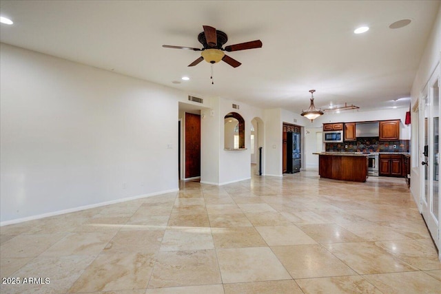 unfurnished living room featuring recessed lighting, arched walkways, visible vents, and ceiling fan