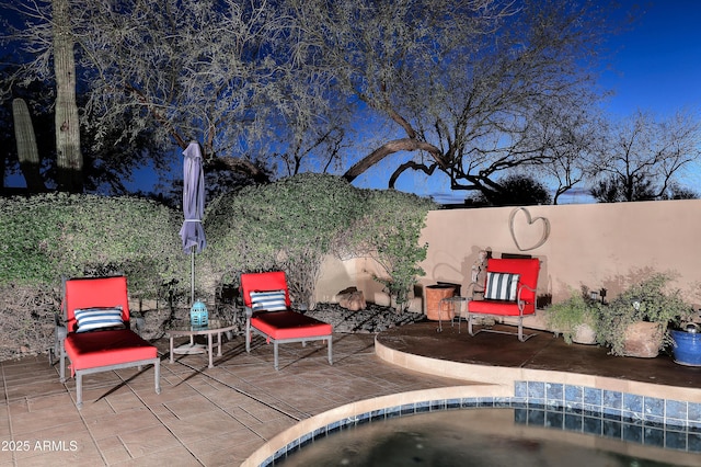 view of swimming pool with a patio and fence