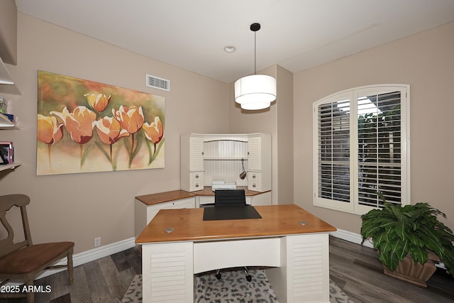 office space with dark wood-type flooring, visible vents, and baseboards