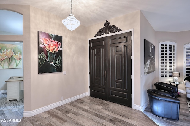 foyer featuring wood finished floors and baseboards