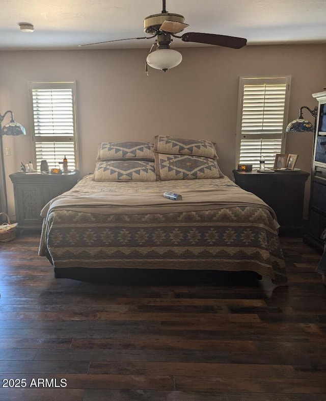 bedroom with a ceiling fan and dark wood-style flooring