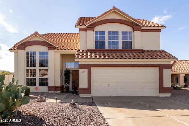 mediterranean / spanish-style house with a garage