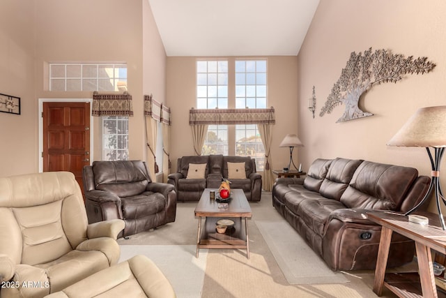 carpeted living room with a towering ceiling