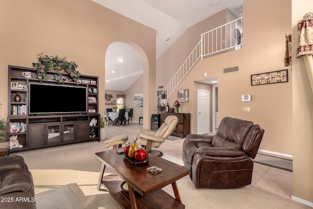 living room featuring a high ceiling and light carpet