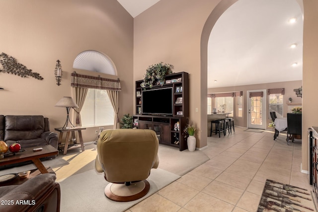 tiled living room featuring high vaulted ceiling