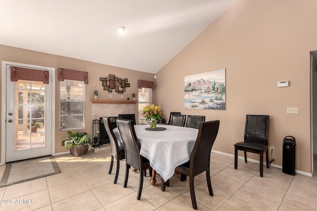 dining space with lofted ceiling and light tile patterned floors