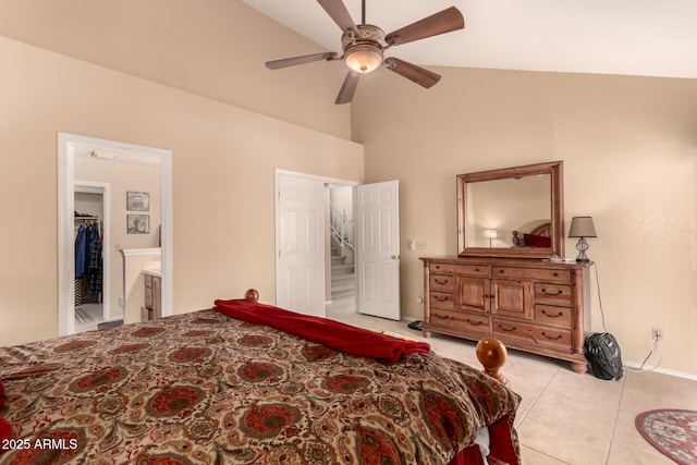 bedroom with ceiling fan, lofted ceiling, ensuite bathroom, and light tile patterned floors