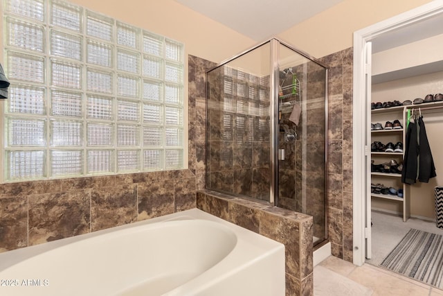 bathroom featuring tile patterned floors and independent shower and bath