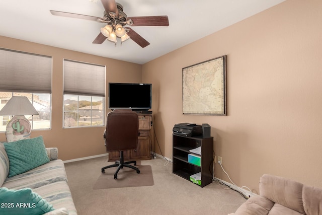 home office with light carpet and ceiling fan