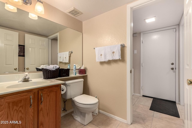 bathroom featuring tile patterned flooring, vanity, and toilet