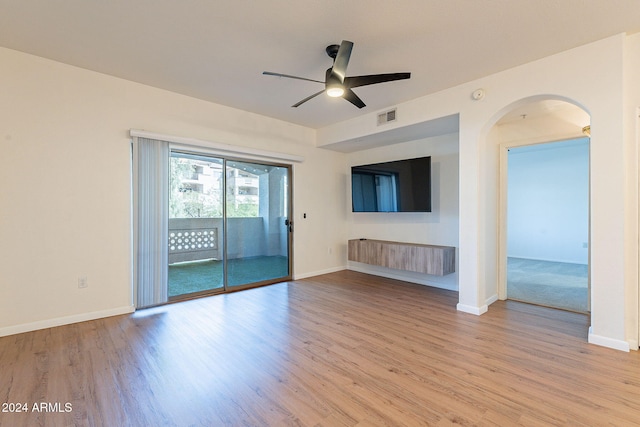 unfurnished living room with ceiling fan and light wood-type flooring